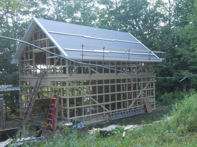 A building under construction with a ladder in front of it