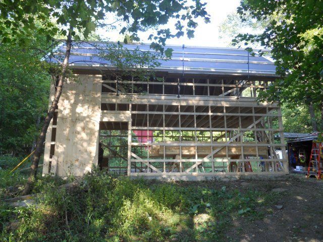 A wooden structure is being built in the woods