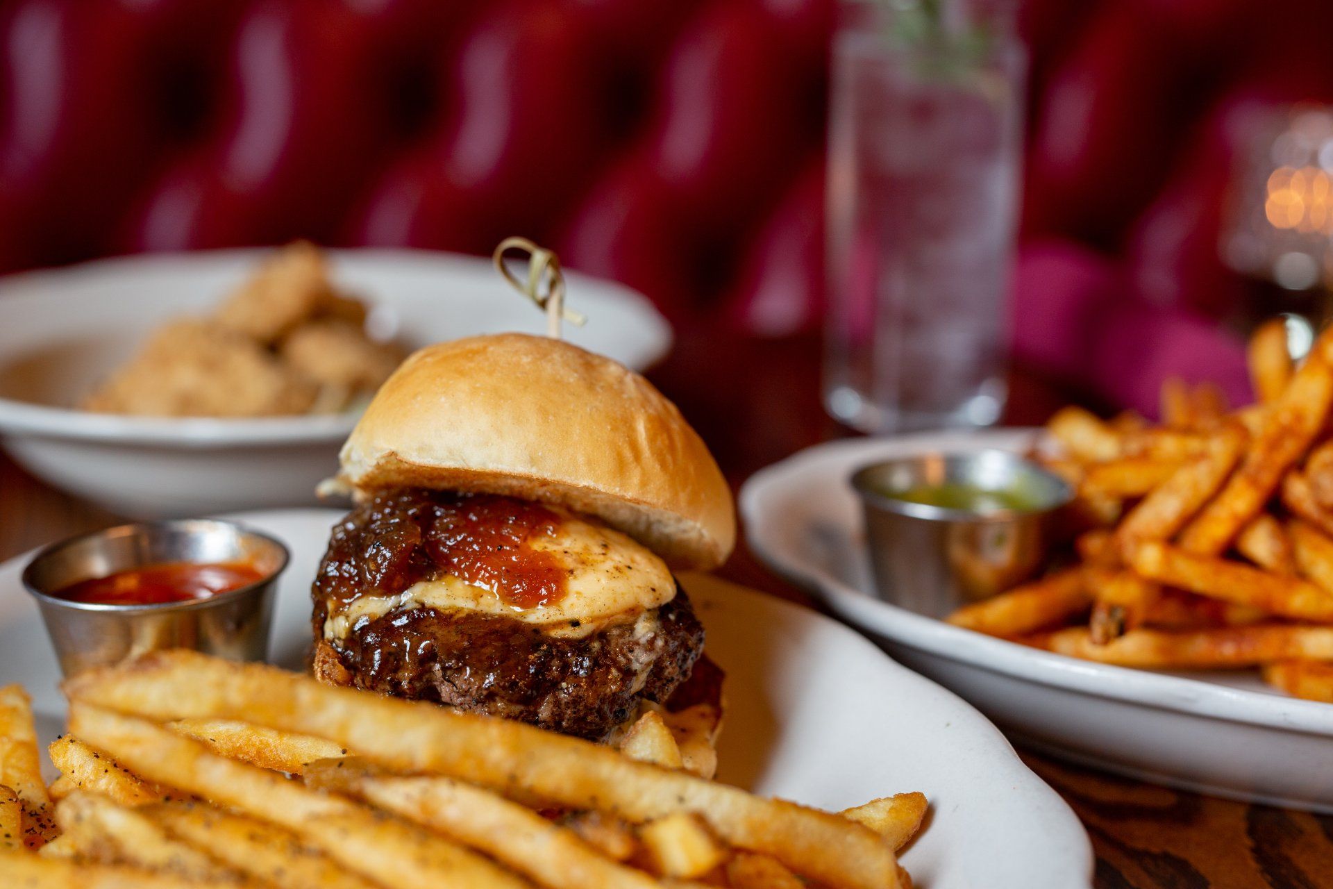 gourmet burger with manchego cheese spread, pickled serrano relish, and spreadable chorizo on a challah bun, with a side of fries at planter's house st. louis