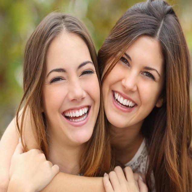 young laughing girls with white teeth
