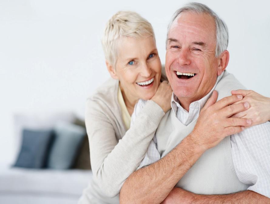 old couple laughing using dentures