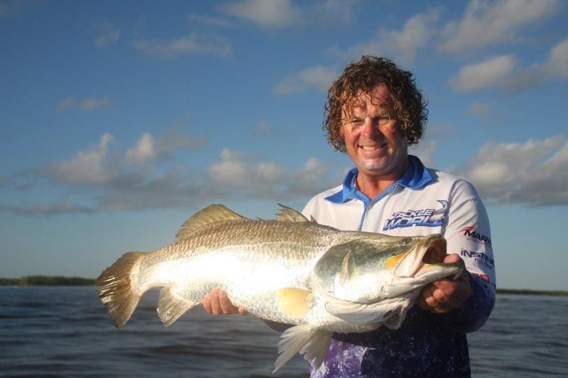 Two men carrying big fish — Barramundi Fishing Darwin in Winnellie, NT