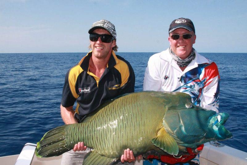 Two men carrying bigger fish — Dean Jackson Guided Tours in Winnellie, NT