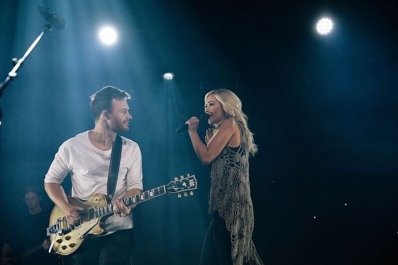 guitar player on stage with singer