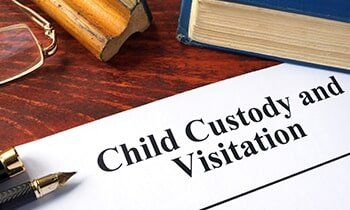 Child Custody and Visitation written on a paper and a book - trial attorney in Dubuque, IA Child Custody and Visitation written on a paper and a book - trial attorney in Dubuque, IA