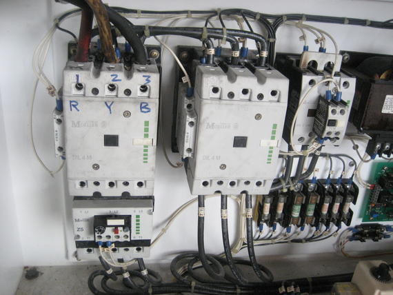 Electrical control panel with three-phase power contactors, labeled R, Y, B, and connected wires.