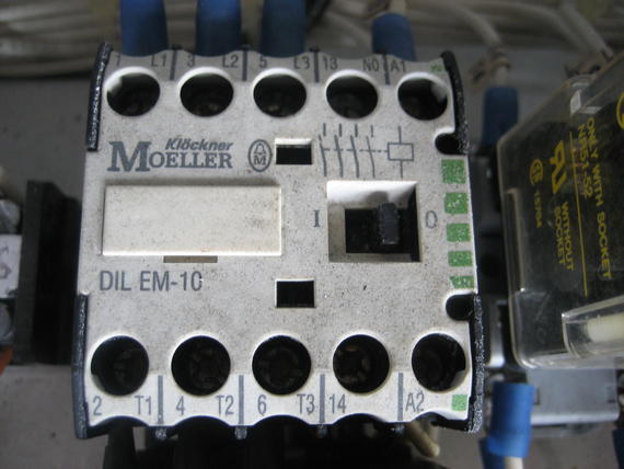 Close-up of a weathered Klockner Moeller DIL EM-1C electrical contactor with several terminals.