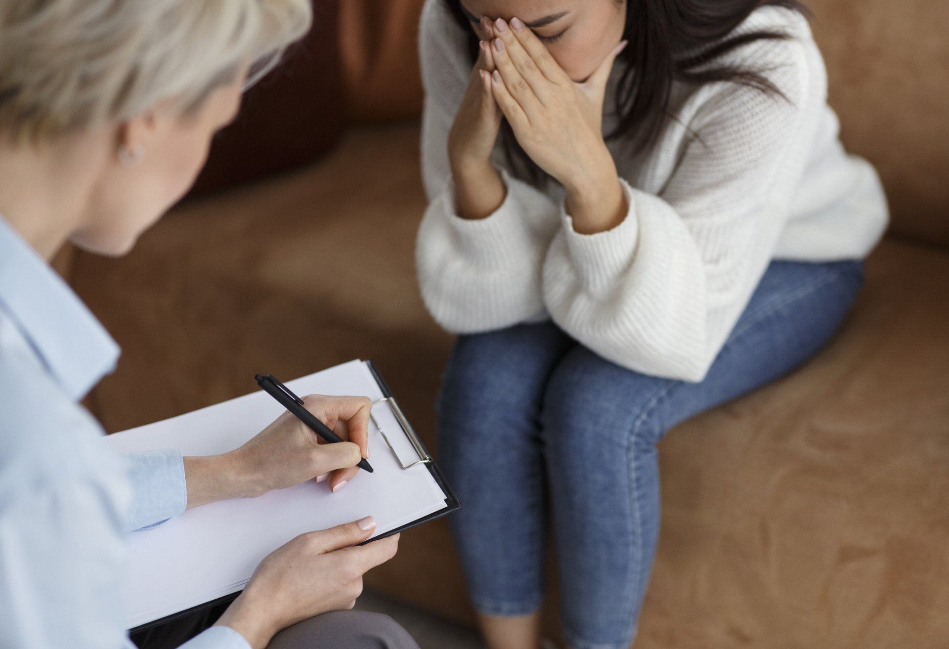 Woman Crying and Psychologist Taking Notes — Tampa, FL — Wellness-Alliance