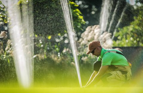 Worker Installing Water Sprinkler System — Butler, NJ — Precision Sprinklers Worker Installing Water Sprinkler System — Butler, NJ — Precision Sprinklers