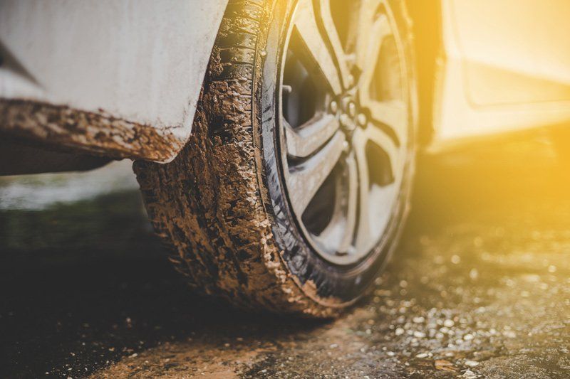 Close Up of Muddy Car Tires — Haltom City, TX — AA Wrecker Service