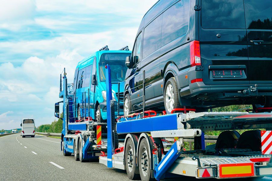 Truck Carrier with Mini Vans on Road — Haltom City, TX — AA Wrecker Service Truck Carrier with Mini Vans on Road — Haltom City, TX — AA Wrecker Service