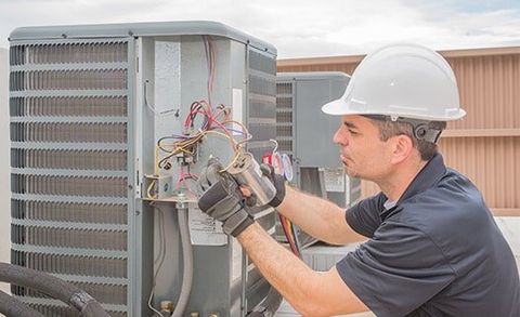Technician and Capacitor — Heating Repair Service in Paso Robles, CA Technician and Capacitor — Heating Repair Service in Paso Robles, CA