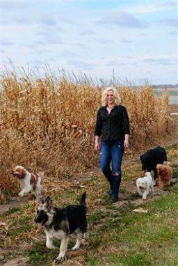 Woman posing with her dogs in a field