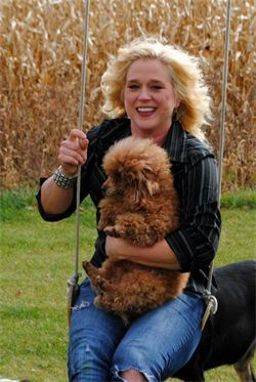Woman swinging outside with her dog
