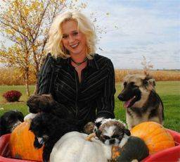 Woman playing with her dogs in her yard