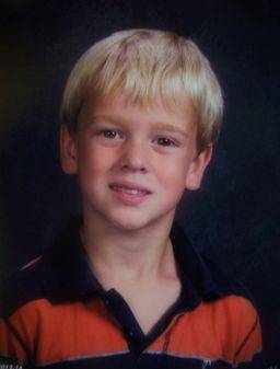 Kimberlee's son smiling for a photo