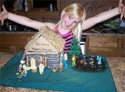 One of Kimberlee's daughters showcasing her mini scale Grinna Homestead
