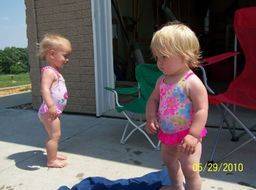 two young girls playing outside on a nice summer day
