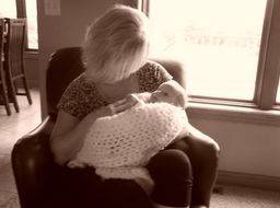 Kimberlee holding one of her children when they were a baby