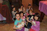 Group of young girls cuddling with puppies