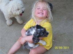 Kimberlee's daughter holding a puppy 