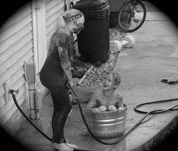 Kimberlee's daughter helping her brother clean up after playing outside