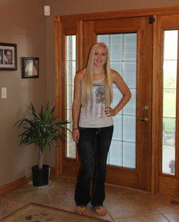 Kimberlee's oldest daughter posing for a photo by their front door