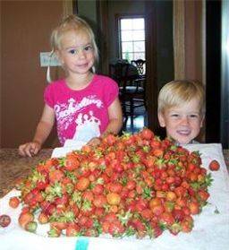 Two of Kimberlee's children helping her in the kitchen