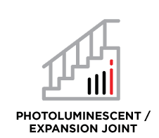 A picture of a staircase with a photoluminescent expansion joint.