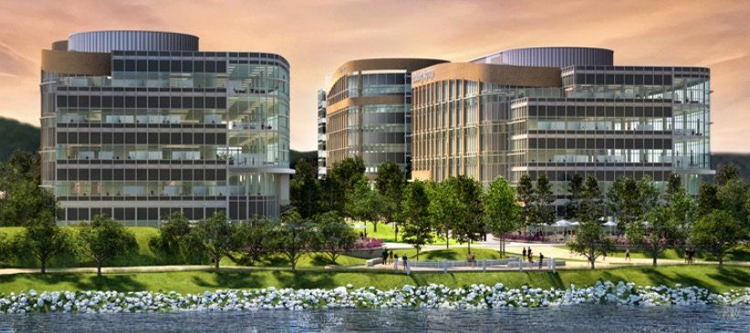 An artist 's impression of a large building next to a body of water.