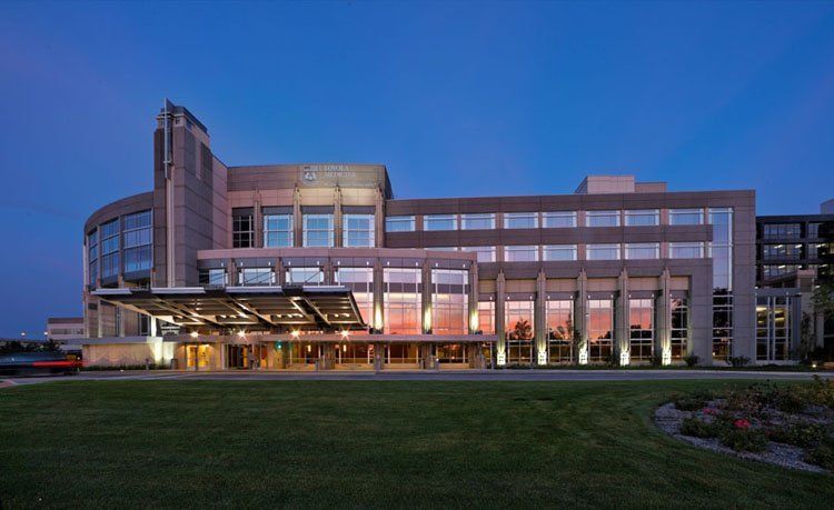 A large building with a lot of windows is lit up at night.