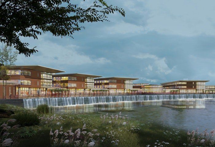 A large building with a waterfall in front of it