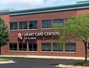 A large brick building with a sign that says heart care centers of illinois.