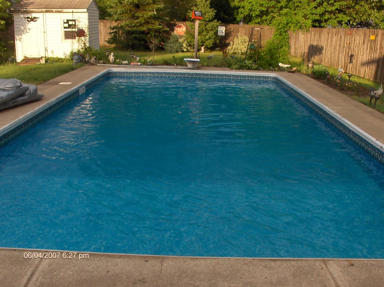 Pool On The Backyard With Wooden Fence — Liverpool, NY — CoolWaters Pool & Spa
