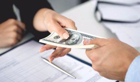 Woman taking batch of hundred dollar bills - Check Cashing in Brockton, Massachusetts Woman taking batch of hundred dollar bills - Check Cashing in Brockton, Massachusetts
