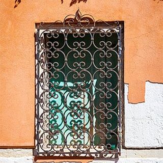 window with decorative wrought-iron grille — window guards in Torrance, CA window with decorative wrought-iron grille — window guards in Torrance, CA