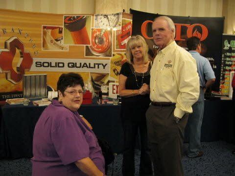 A group of people standing in front of a sign that says solid quality