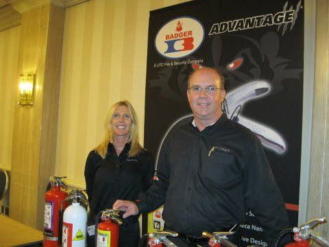 A man and a woman are standing in front of a sign that says advantage.