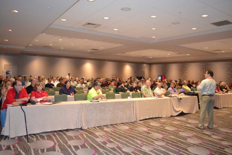 A man is giving a presentation to a large group of people