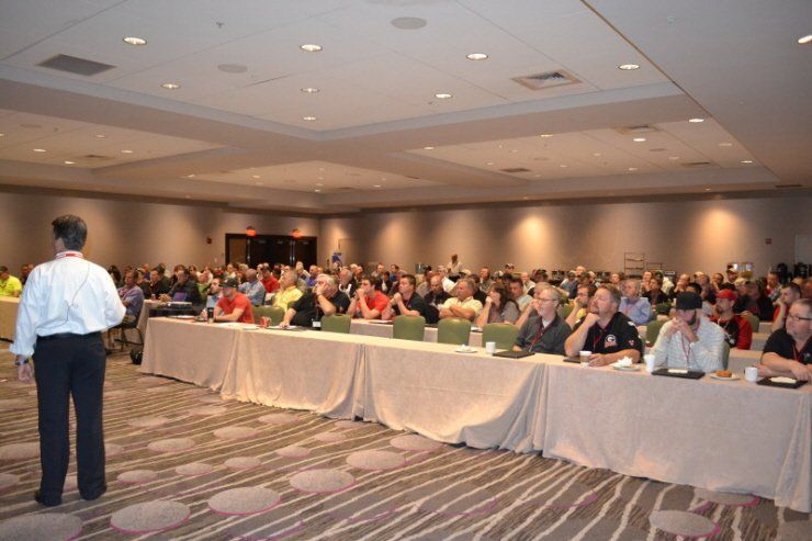 A man is giving a presentation to a large group of people
