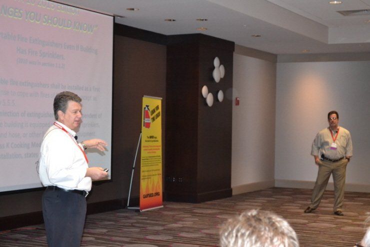 A man is giving a presentation in front of a projector screen
