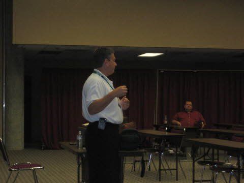 A man is giving a presentation in front of a group of people