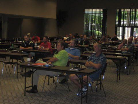 A group of people are sitting at tables in a room