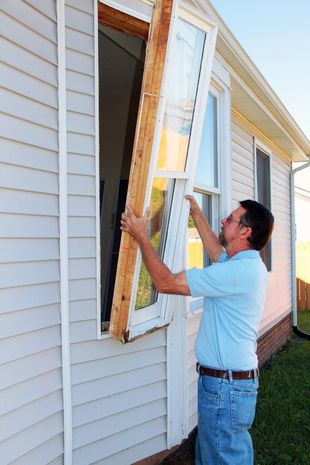 Man fixing window — Residential & Commercial Glass Replacement in Anaheim, CA Man fixing window — Residential & Commercial Glass Replacement in Anaheim, CA