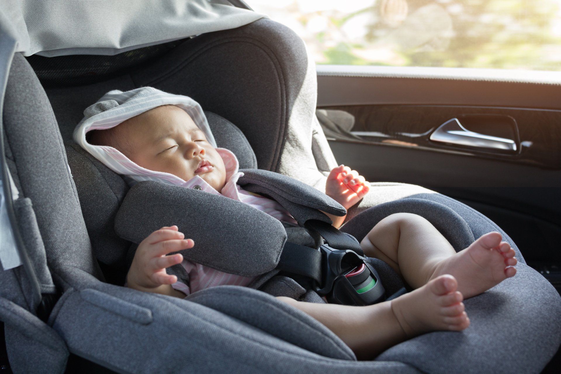 Close Up Asian Cute Newborn Baby Sleeping In Modern Car Seat — Denver, CO — Mr. Sids Fine Auto Upholstery