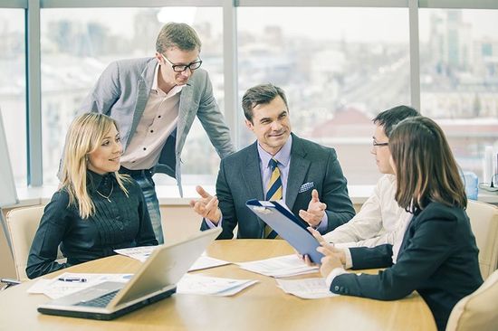 Gruppo di persone alla scrivania che discutono di lavoro