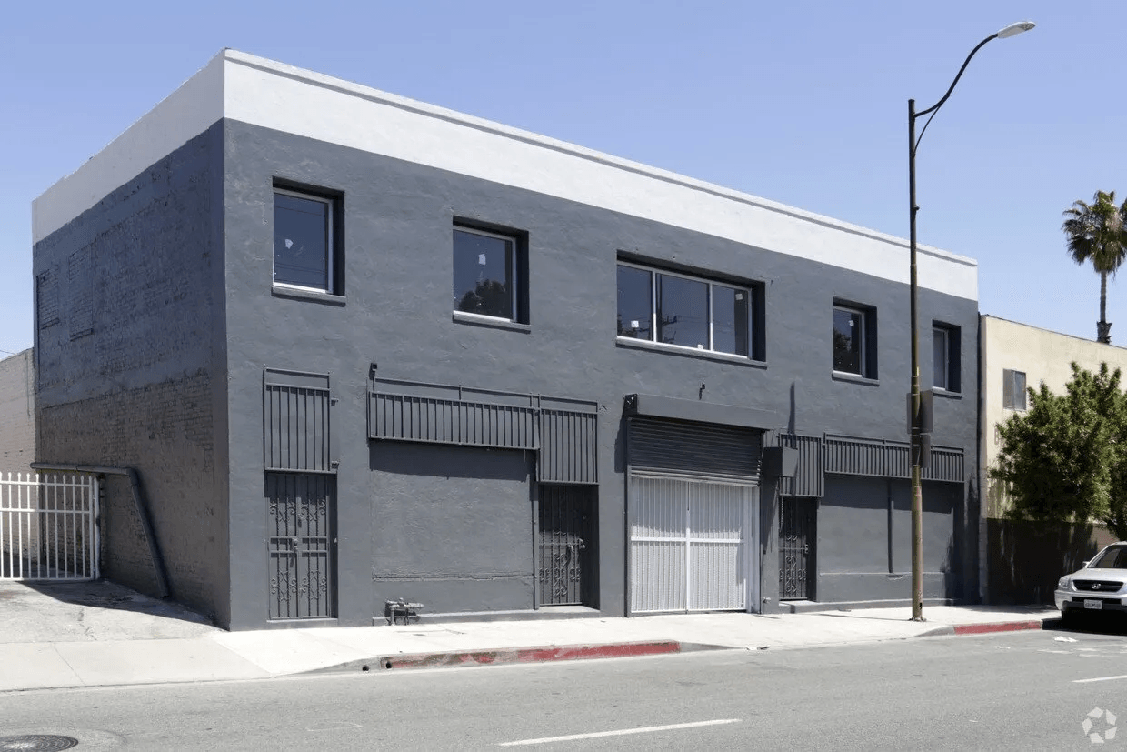 A building with a lot of windows and a car parked in front of it