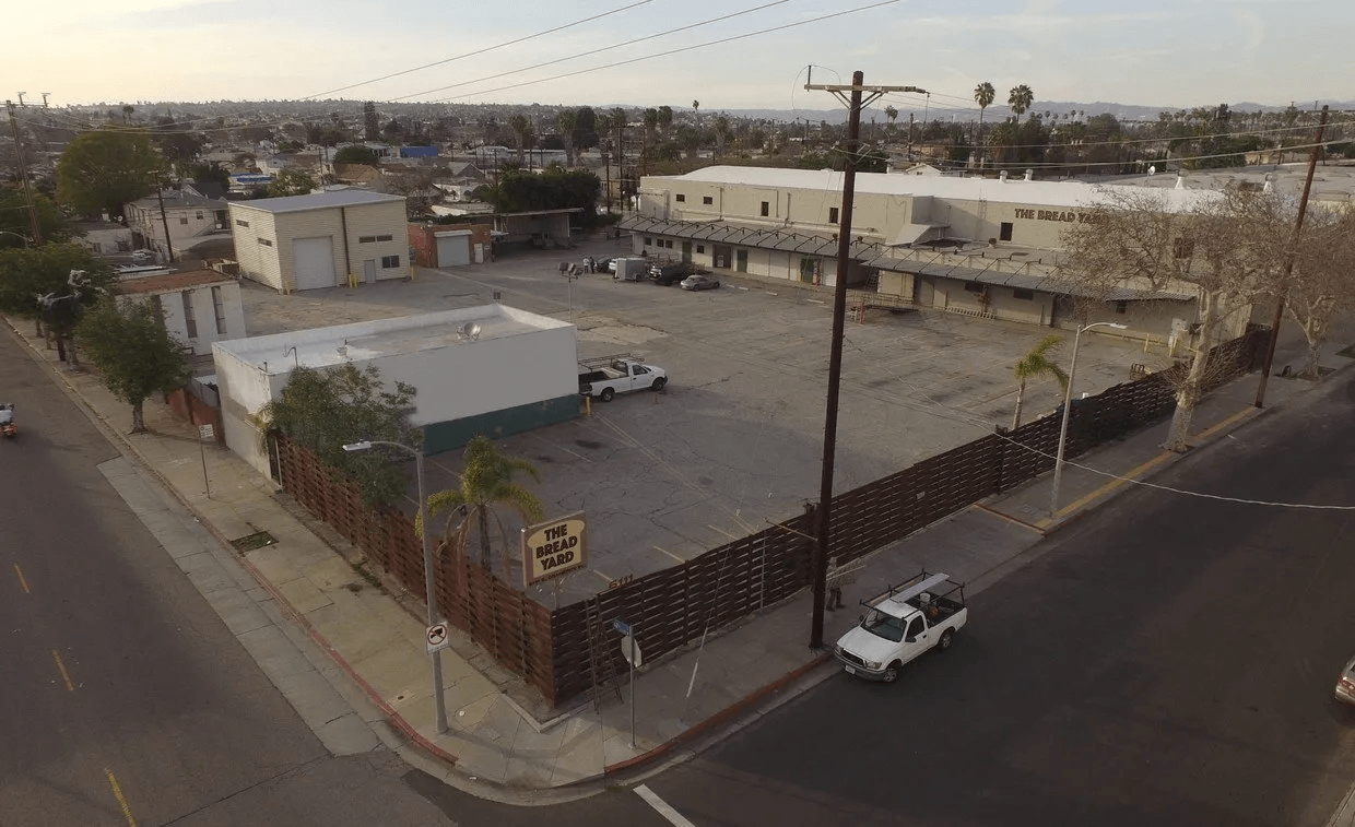 An aerial view of a parking lot with a no parking sign on the side of the road.