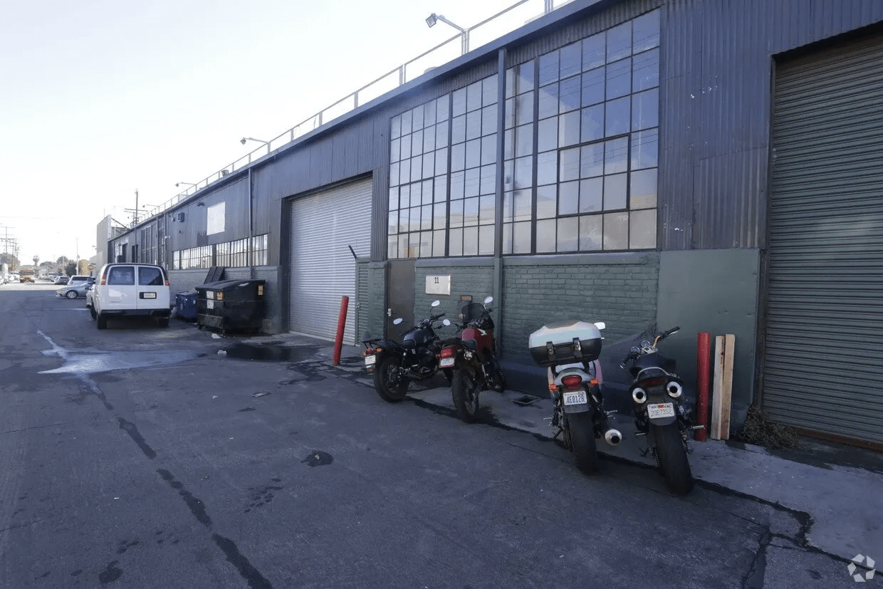 A row of motorcycles parked in front of a building