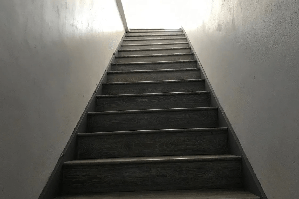 A set of stairs leading up to a light.